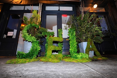 As a creative take on signage, a topiary outside the venue spelled the designer's name, with each letter measuring three feet high by two feet wide.