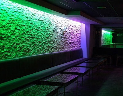 Banquettes line the perimeter of the nightclub.