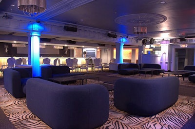 The club holds 382 guests, with the main lounge featuring couches and zebra-print carpet.