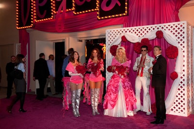 In recognition of Las Vegas's moniker 'the Marriage Capital of the World,' an Elvis impersonator mock-married a young couple decked out in the reception's dominant color of pink.