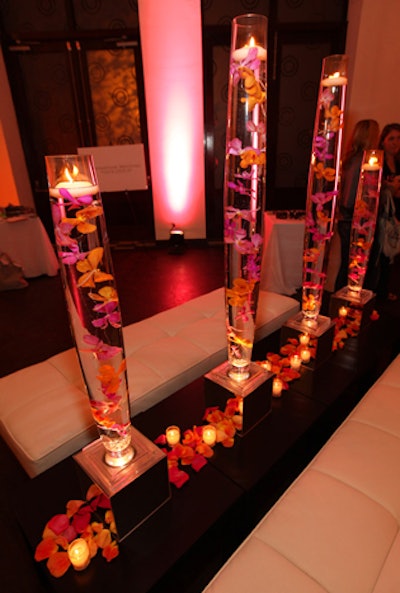 Richard Remiard Event Design created flower arrangements in Glossed & Found's signature colors, pink and orange.