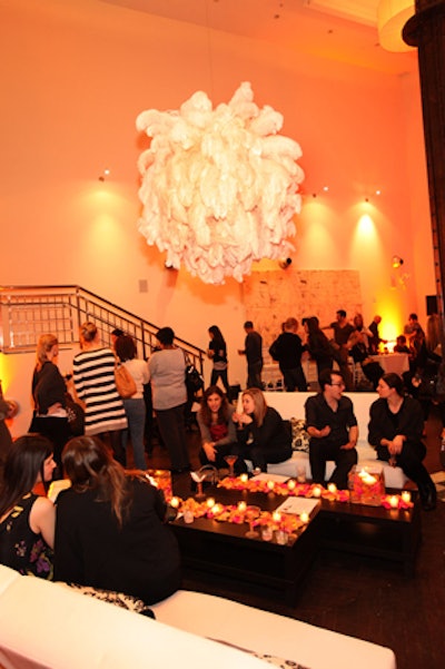 Richard Remiard Event Design's decor included feathery chandeliers and tables covered in pink and orange rose petals.