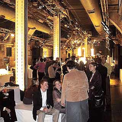 Food & Wine's event planners lit Frame's steel columns with white lights. White cube seating was scattered throughout the room.