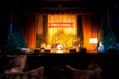 Couches and lounge furniture at the front of the ballroom's space created a living-room-style setting for the event's V.I.P.s, including the show's stars Fred Armisen and Carrie Brownstein. Hidden by the projection screen during the show viewing, the stage housed the band for the premiere's party.
