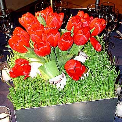 Other centerpieces by Belle Fleur featured red tulips planted in a bed of wheatgrass with baseballs beneath it.