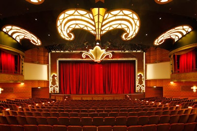 The Walt Disney Theatre is decorated in rich red and gold hues reminiscent of old Hollywood, but equipped with an array of advanced technology.
