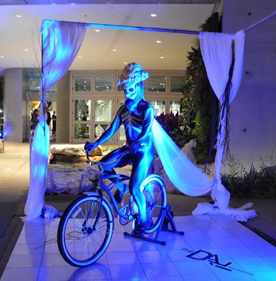 On either side of the entryway, two skeleton-clad bicyclists pedaled as guests arrived, in an eerie portrayal of Dali's 'Sentimental Colloquy.'
