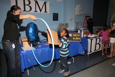 At I.B.M.'s 'Breezy Blimps' station, children learned about lift and gravity while trying to coax a helium balloon through a hula hoop using just a piece of cardboard.