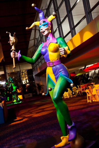 Twelve-foot-tall jesters in yellow, green, and purple punctuated the cocktail-hour space.
