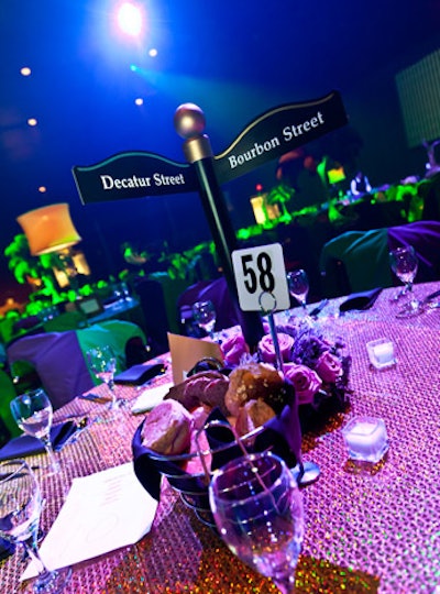 In the main party space, four different centerpieces topped tables, including New Orleans street signs surrounded by flowers from Brattle Square Florist.