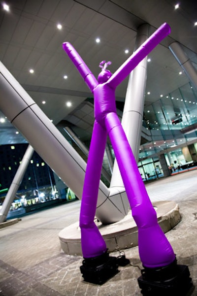 Outside the Boston Convention and Exhibition Center, inflatable dancers in purple and green set the tone for the Mardi Gras evening.