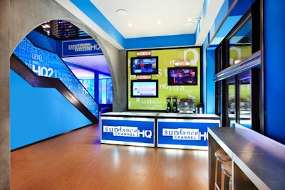 On the wall, screens showcase the channel's online, on-air, and live studio content.
