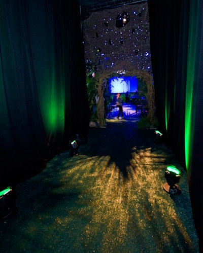 Decorators maintained the theme into the hallway to the restrooms, covering the floor with green turf and hiding the walls with black drapes illuminated with green lighting.