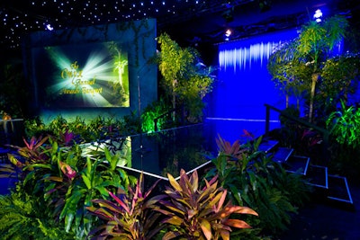Tropical plants surrounded the black lacquer stage, which was flanked by a waterfall in the rear and, on either side, video screens surrounded by faux rock.