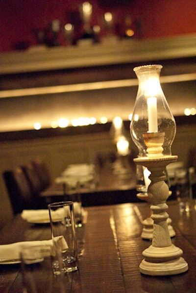 Lanterns top rustic wooden tables in Mass Ave's open dining room.