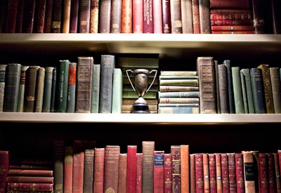 Vintage books fill a built-in bookshelf, lending a collegial, academic feeling to the space.