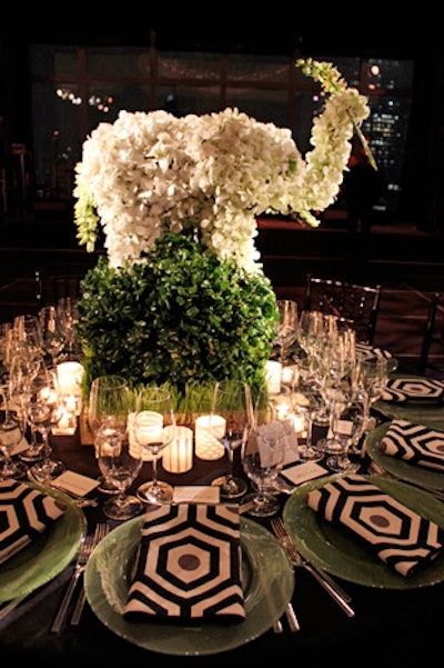 Timothy Whealon and L'Olivier Floral Atelier went for a classic yet preppy look with bold black and white printed napkins set against green chargers, and a whimsical elephant made of white orchids.