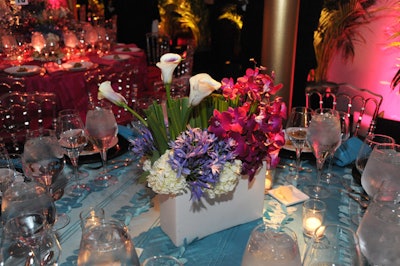 Volanni created two centerpiece designs mixing white hydrangeas, callas lilies, orchids, and greenery.