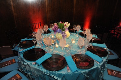 DC Rental mixed blue, pink, orange, and steel gray linens with clear, white, and black chargers.