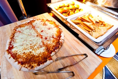 Spreads of teen-friendly snack foods, including pizza, sliders, and mini grilled-cheese sandwiches, filled two self-serve food stations.