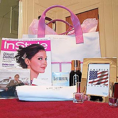 Kate Spade's canvas and pink leather gift bag (custom made for the event) contained an issue of In Style, Elton John's latest CD, a box of Harmony cereal for women, a silver plated picture frame, an Estee Lauder lipstick and nail polish, a can of Aramis shaving cream and Kate Spade garment bag.