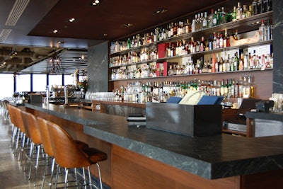 An updated soapstone chef's rail gives diners an opportunity to watch chefs at work.