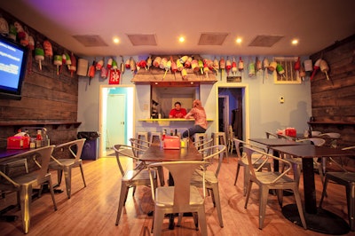 Buoys, wood paneling, and ocean-blue paint adorn the walls of Crackle Bar.