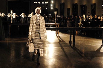 Accompanied by 'How Do You Solve a Problem Like Maria?' from The Sound of Music, Thom Browne's unconventional presentation created a churchlike setting with a makeshift altar inside the New York Public Library. Female models wore habits, which they removed with the help of male models in altar-boy-style outfits before walking the runway.