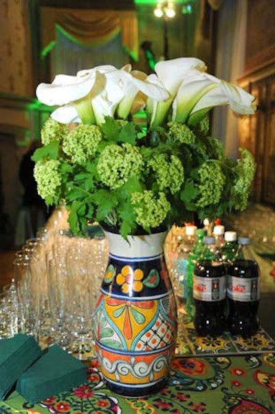 Floral arrangements of hydrangeas and calla lilies in colorful Mexican-style vases topped the bars.