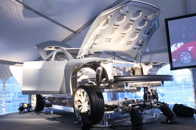 Tesla displayed an enlarged shell, known as an alpha build, of the Model S sedan on a raised platform to showcase the electrical workings of the power train underneath.