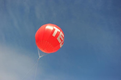 A logo balloon caught attention overhead.