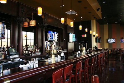 Flat-screen TVs line the walls behind the bar and seating areas.
