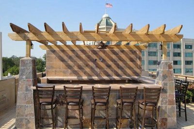 A slate bar at the center of the rooftop has 10 movable bar stools.