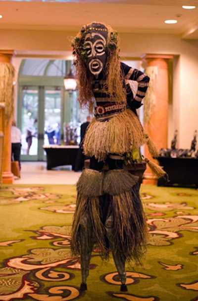 Moko jumbies, masked stiltwalkers whose history dates back to ancient Africa, walked around during the reception.