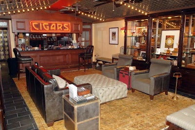 The furniture in Nat Sherman's downstairs smoking club forms a lounge with tufted ottomans, leather armchairs, and side tables styled after old-fashioned trunks.