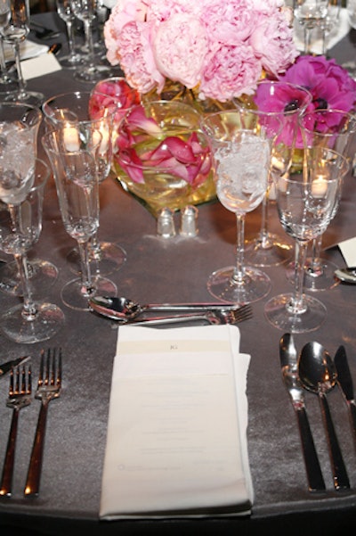 To play up the circular enclosures used to display the jewels in the Van Cleef & Arpels exhibition, the dinner's centerpieces included fuchsia anemones, submerged calla lilies and French tulips, hydrangea, and pale pink peonies in glass bubble vases.