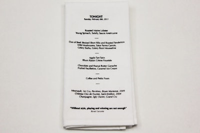 To simplify the decorations at its dinner, Lacoste used chairs marked with numbers instead of place cards and printed the night's menu on napkins.