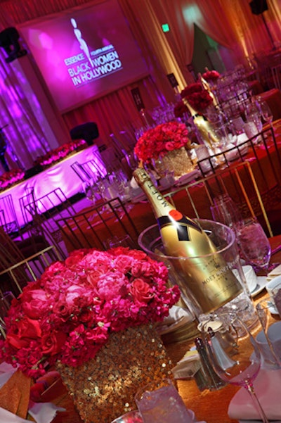 Custom sparkly gold linens and voluminous arrangements of fuchsia and magenta peonies and roses topped tables