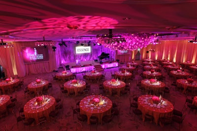 Magenta lighting from Lighten Up washed the ballroom, done in gold tones with pops of hot pink.