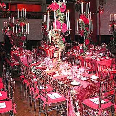 Designers Ron Wendt and Robert Rufino used red tablecloths and tall candle centerpieces for the red-themed New York City Opera's Thrift Shop benefit.