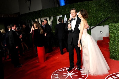 Colin Firth and his wife, Livia Giuggiol, arrived at the Vanity Fair Oscar party hosted by Graydon Carter at Sunset Tower after the ceremony on a carpet with logo insets and backdrop.