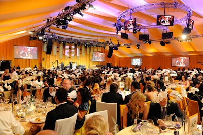 For the look of Elton John's party, producer Virginia Fout explained that 'the goal was to try to translate gold,' with lots of gold accents, reflective dance floor, hanging square tiles, with infusions of mango, beige, off white.'