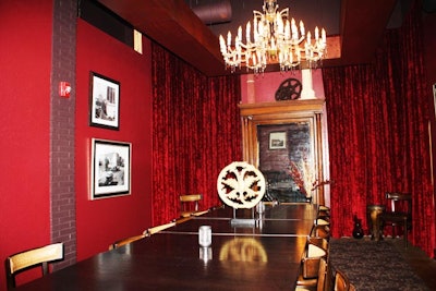 The semi-private dining room has seating for 25 at one long table and two high four-tops. Red velvet drapes accent the walls and are also used to partition the room from the main dining area.