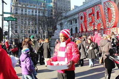 Staffers outfitted in red-and-white striped hats and scarves passed out cups of hot cocoa before and after the installation's 8:30 a.m. unveiling.