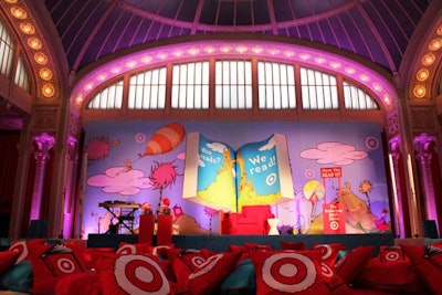 For the Thursday morning event, the mass retailer also created a branded reading room inside the library's Celeste Bartos Forum. In this space the producers built a large book-shaped sculpture for the stage, stored hundreds of Dr. Seuss books in custom shelves, and spread pillows emblazoned with a furry, Seuss-style illustration of the Target logo across the floor.