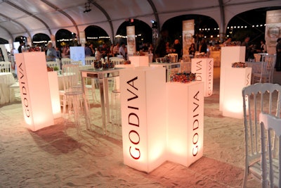 Godiva's beach top activation at Bubble Q included individually-wrapped chocolates. The brand also served a dessert called 'Midnight on the Beach,' inspired by its Midnight Swirl chocolate.