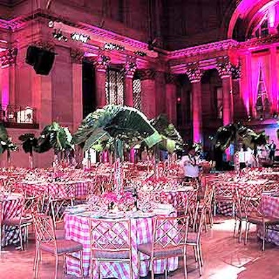 Bill Tansey decorated the banquet tables with towering monstera leaves and single-type flower bouquets at the base of the arrangements.