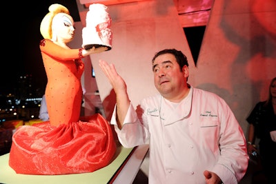 Event co-host Emeril Lagasse inspected the chefs' cake designs.