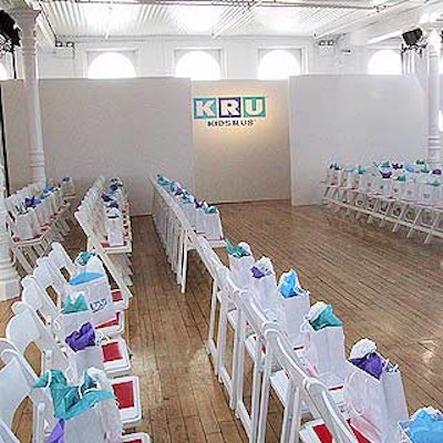 For the Kids 'R' Us fall fashion show at the Puck Building, Kadan Productions built a simple white backdrop and set the chairs in a runway format.