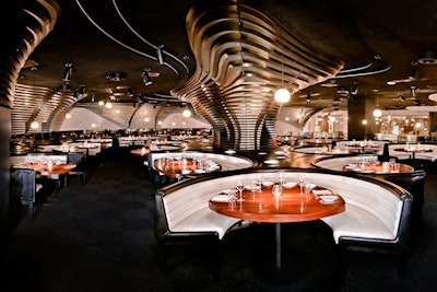 A large central lounge has creamy leather banquettes and textured crocodile tiles, and is surrounded by an elevated dining room for more formal dining.
